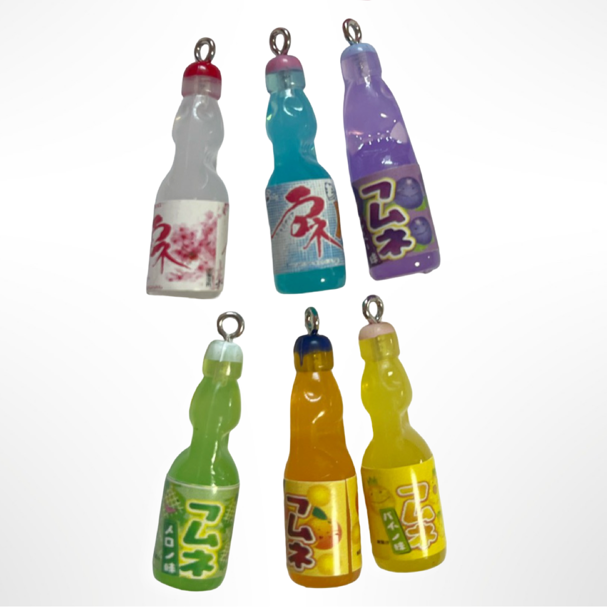 Set of colorful bottle-shaped charms on a white background